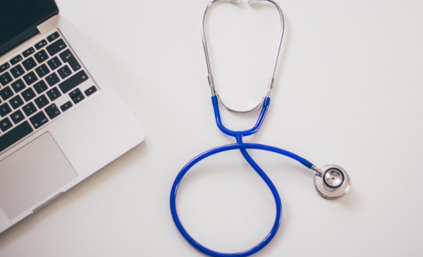 a stethoscope next to a laptop
