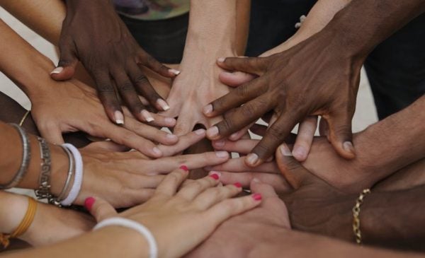 diverse hands stacked in solidarity