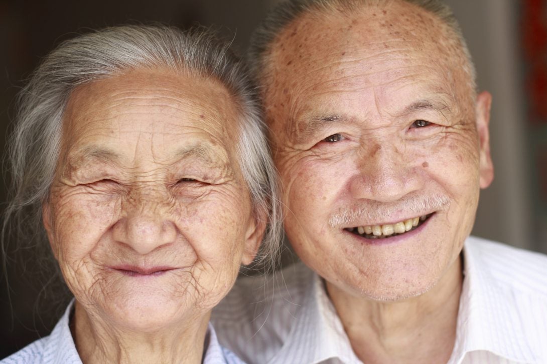 smiling elderly asian couple