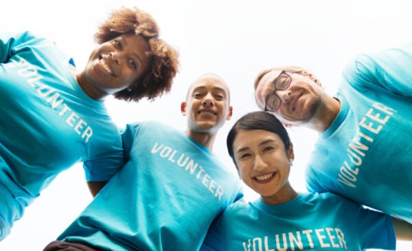 volunteers smile down at a camera