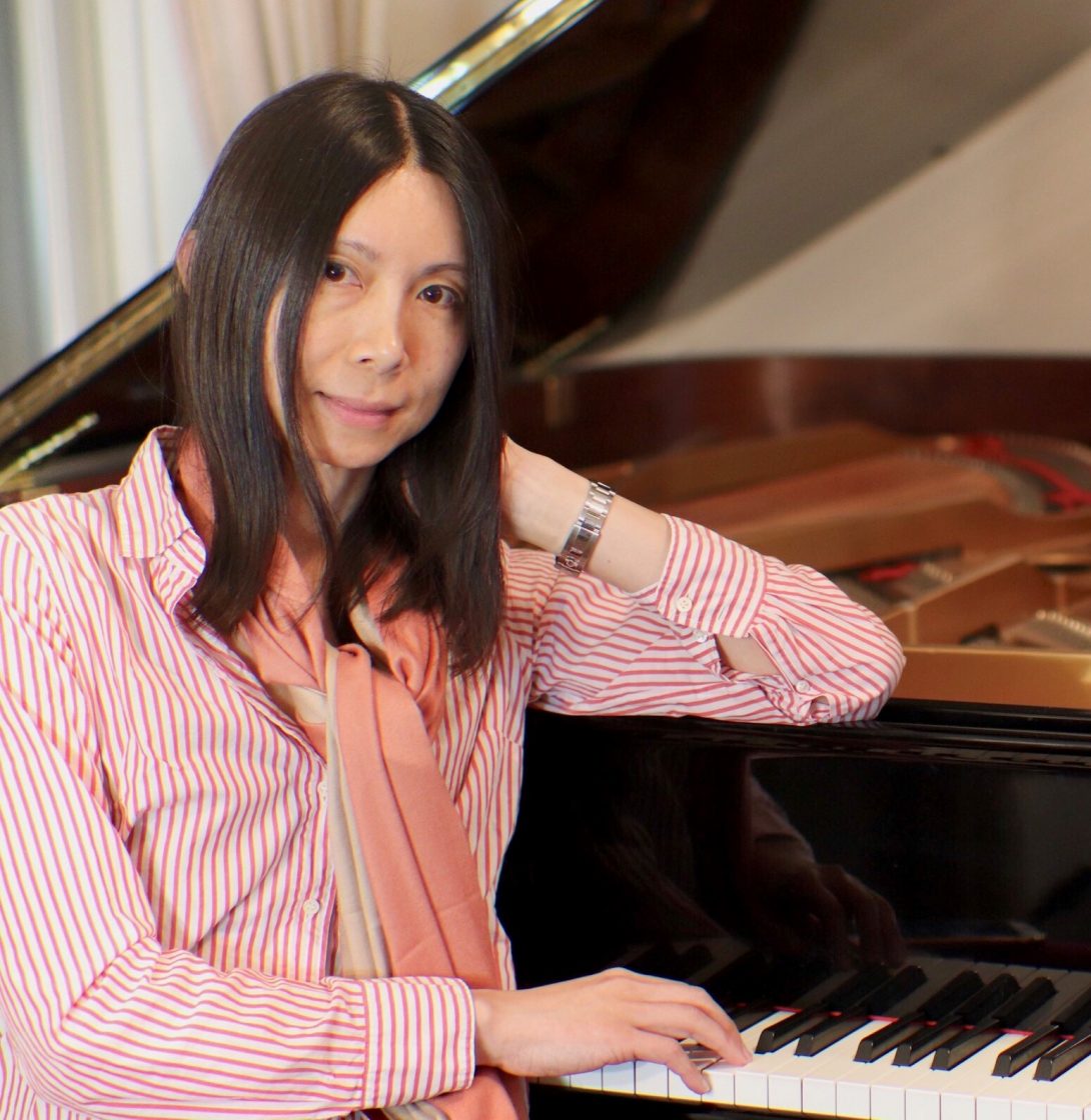 doctor Alex Leow seated at her piano