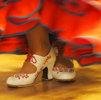 Flamenco dancer's shoes and skirt. Photo credit: Val Carr for Getty Images via Canva. 