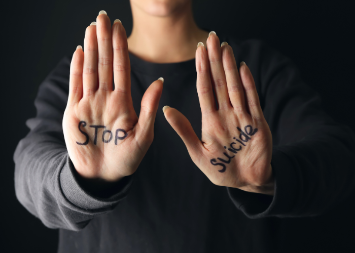 hands with the words stop suicide