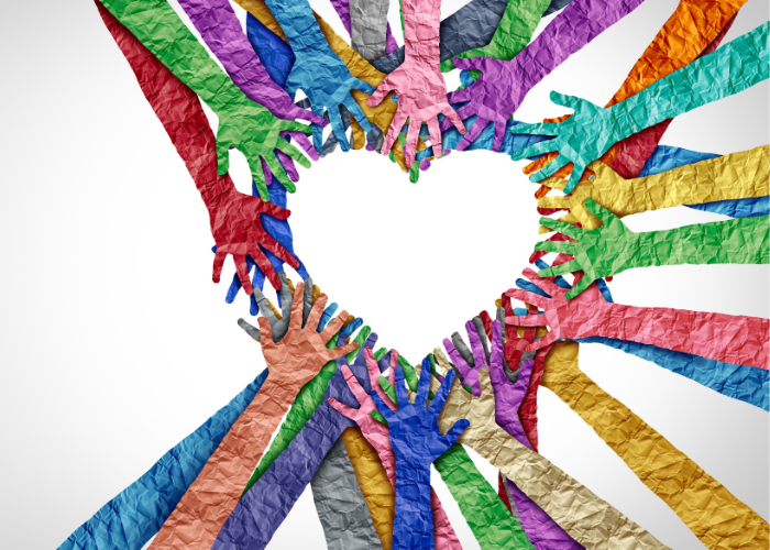 Multicolored paper hands reach out to form a heart shape. Courtesy of wildpixel for Getty Images.