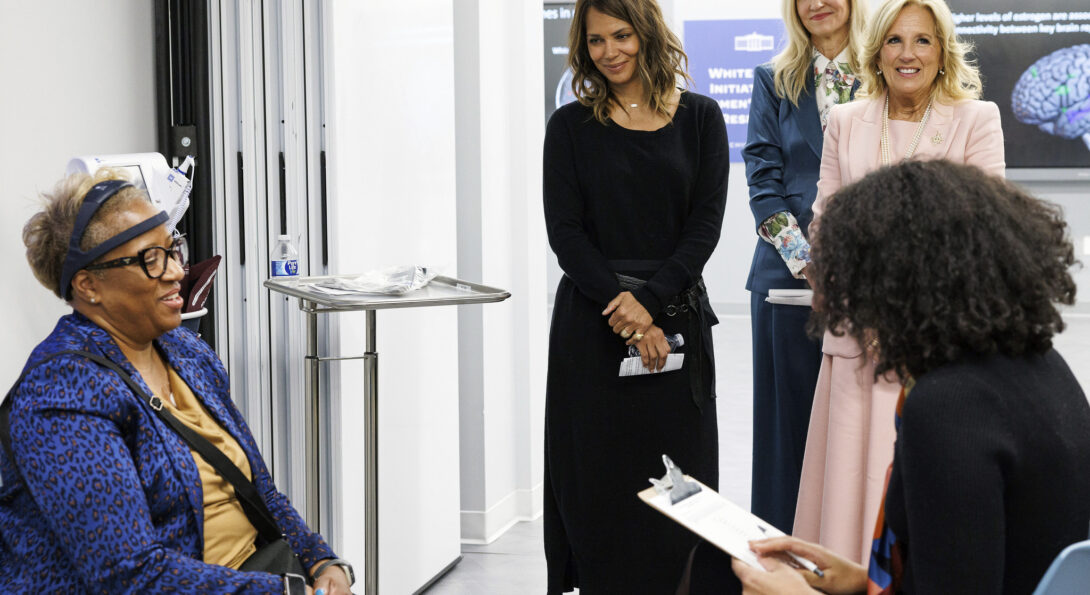 Maki looks on as a research participant demonstrates wearable menopause technology to First Lady Dr. Jill Biden and actress Halle Berry