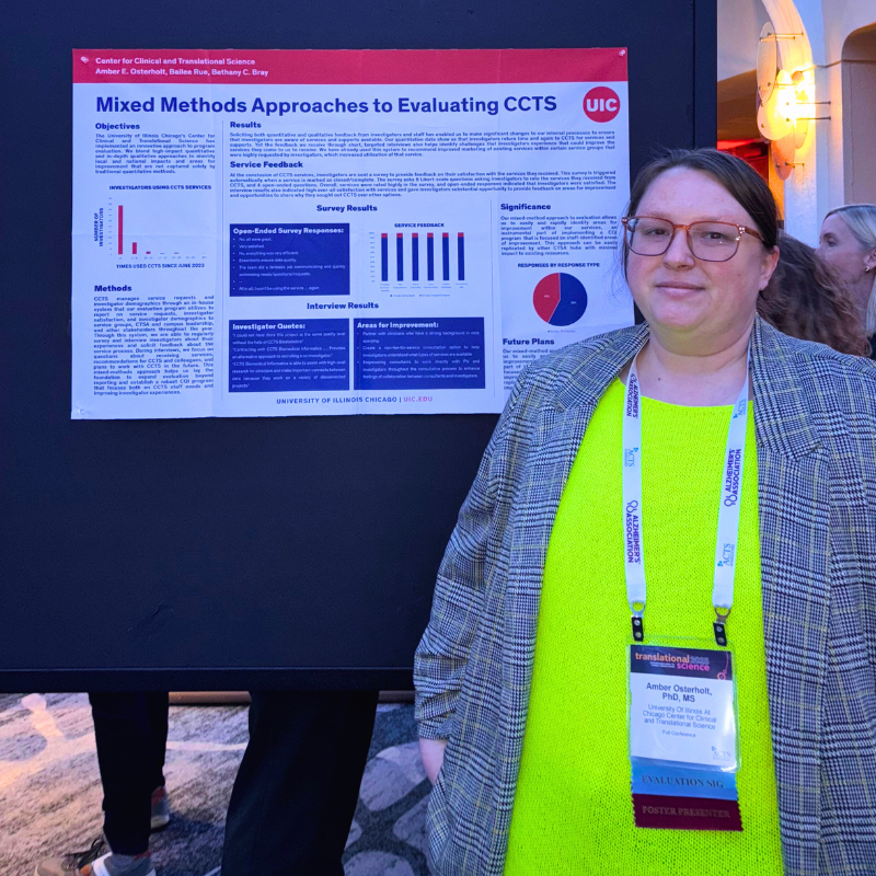 Dr. Amber Osterholt stands in front of her poster at TS 2025